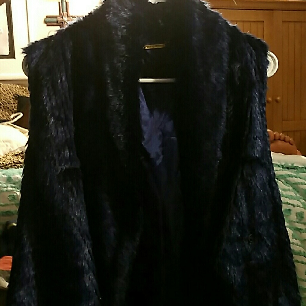 A blue fluffy vest Steve Madison